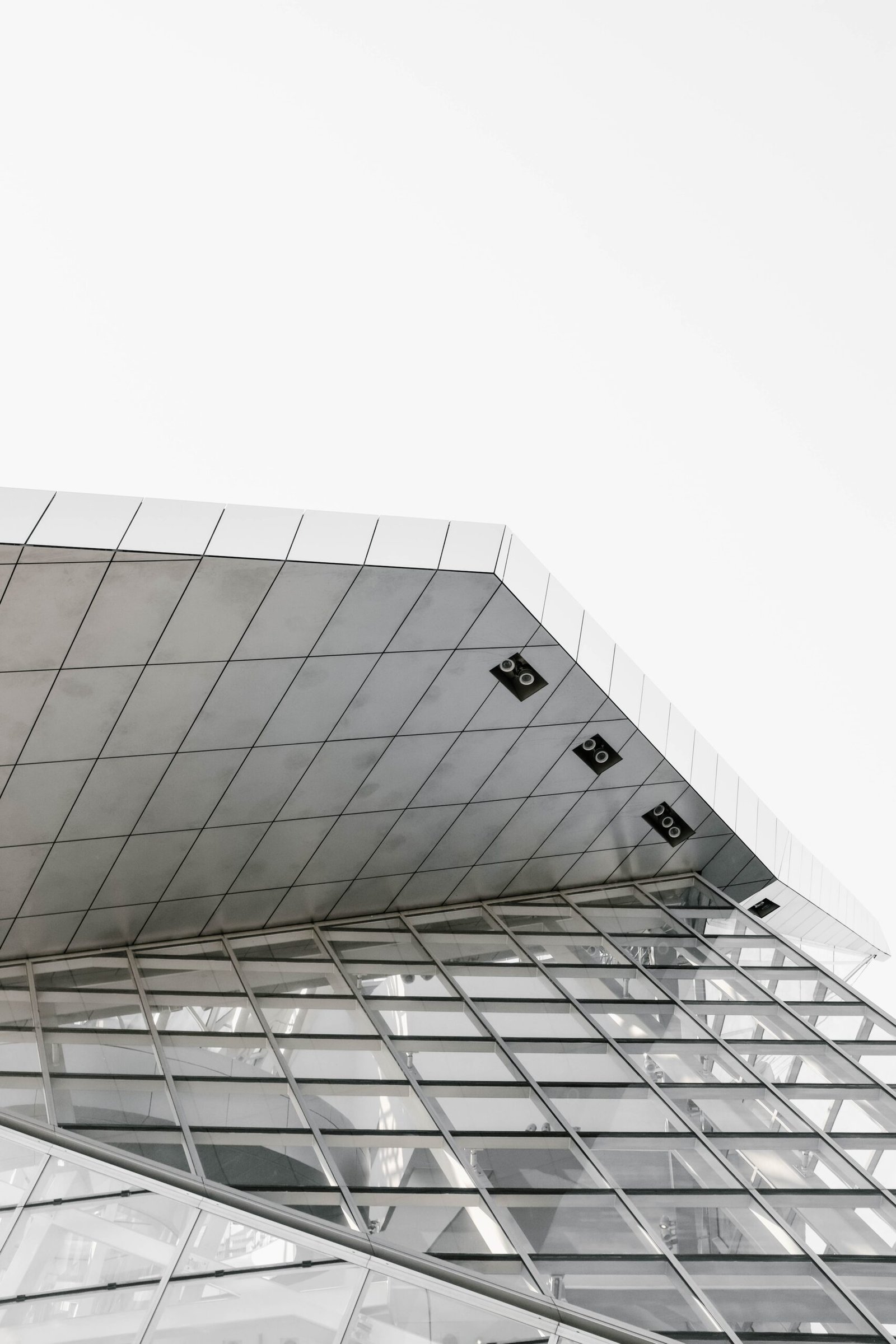 vertical grey scale shot of a geometrical structure captured from a low angle